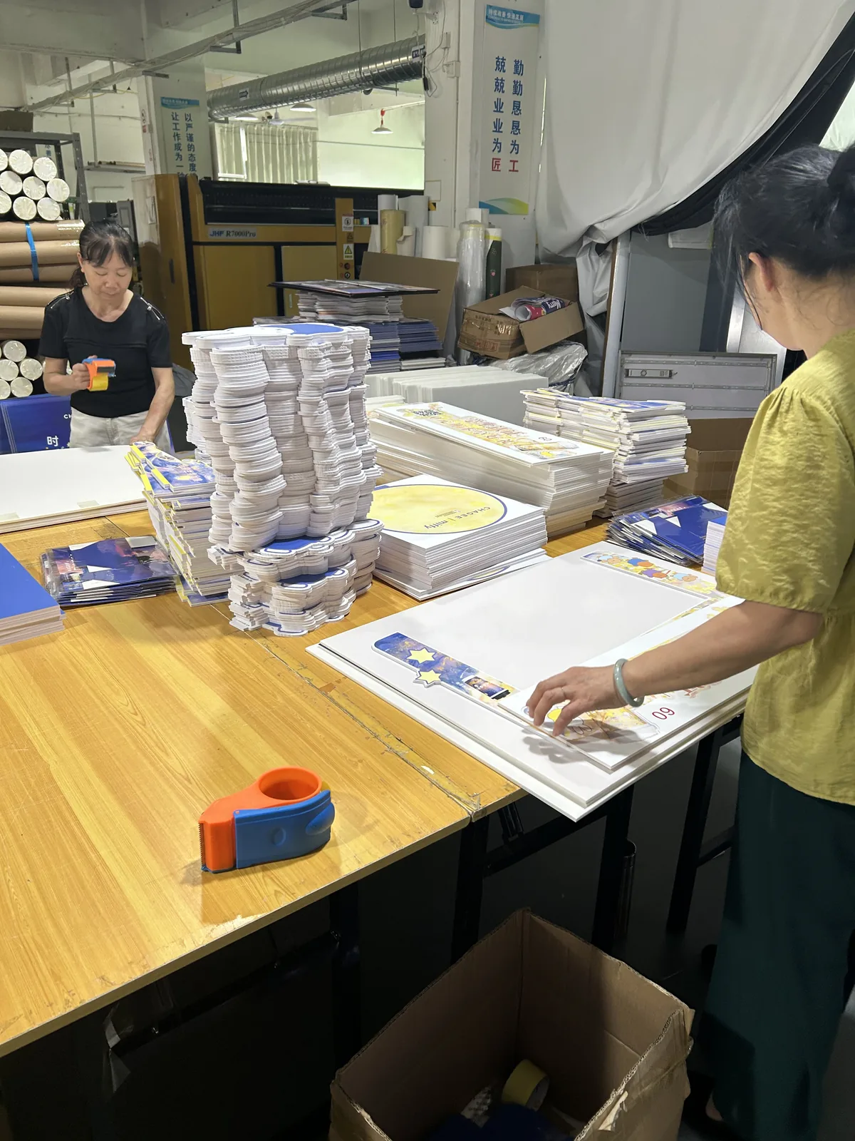 Printed items and components sorted and checked in sets.