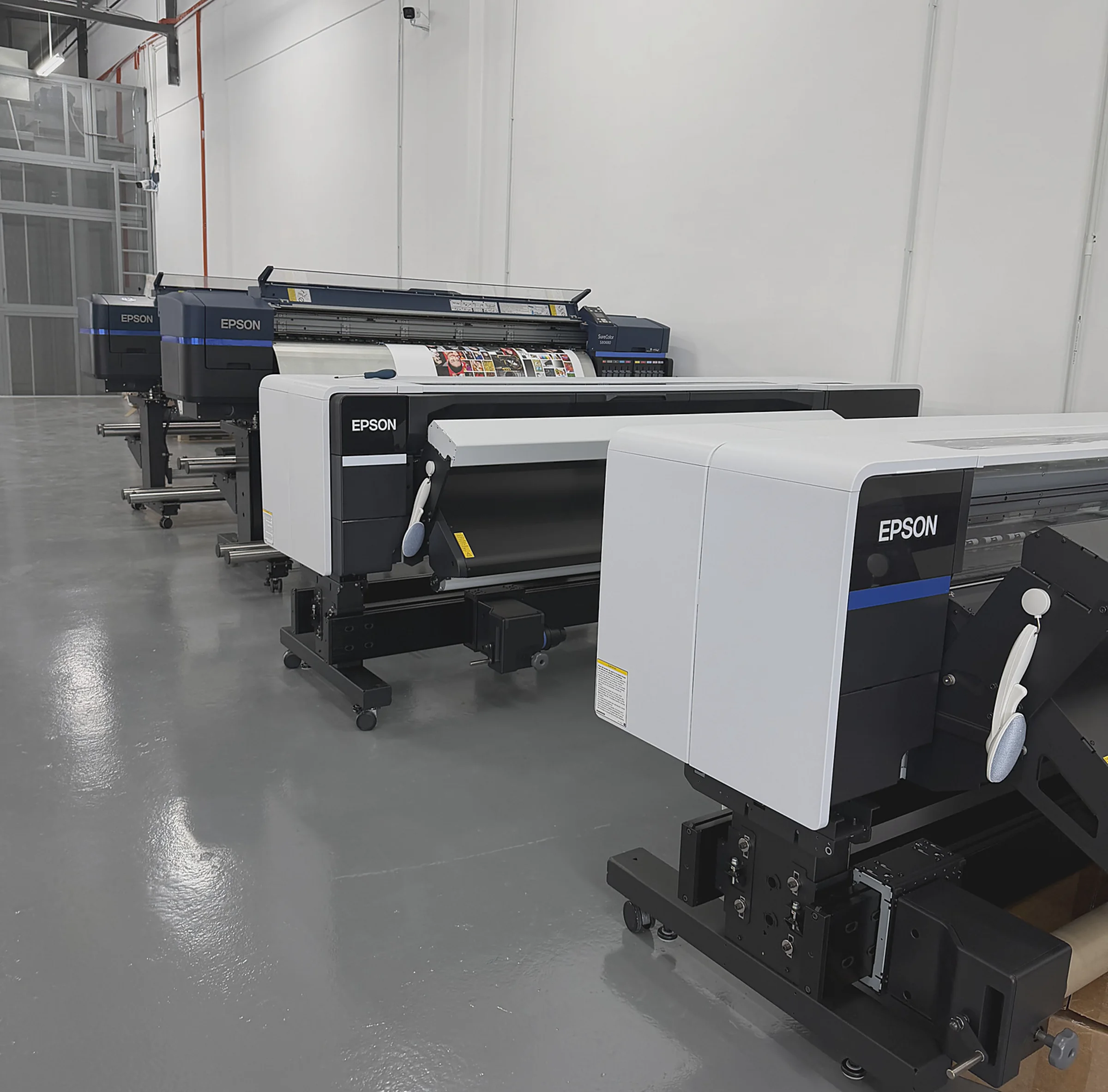 Large-format printers operating in the workshop