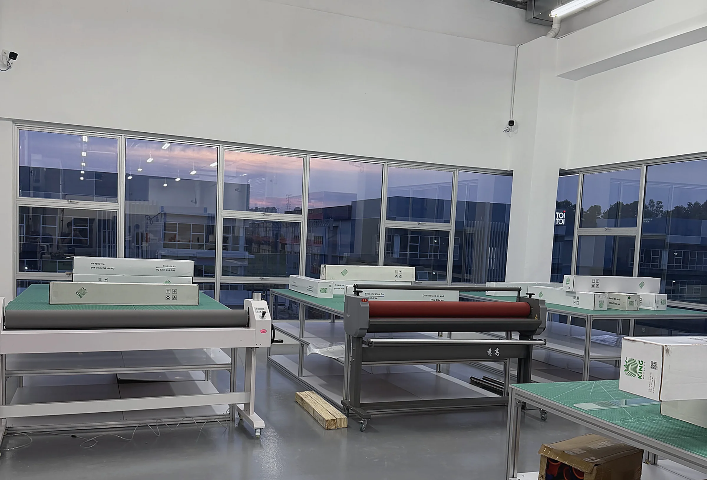 Laminating equipment and finishing tables in the HGS workshop