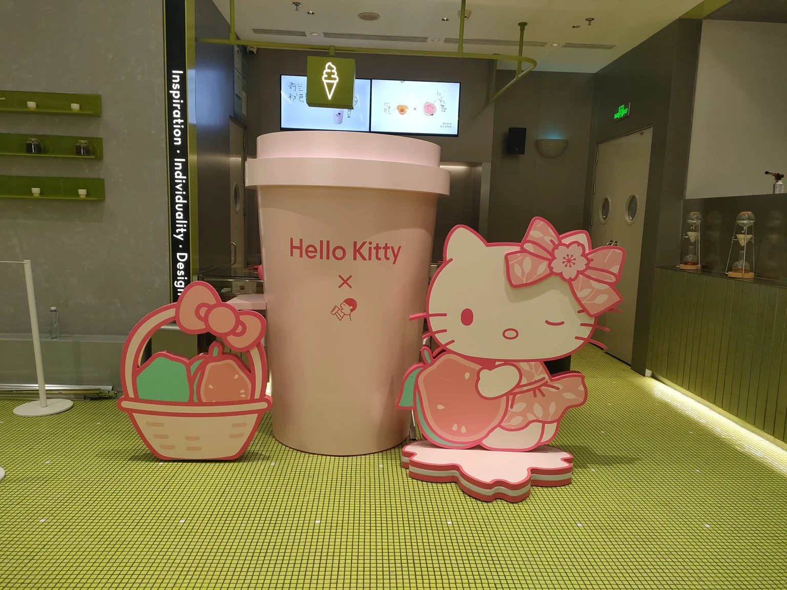 Oversized cup prop and layered character standees installed in a retail space